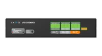 从前上方俯视黑色 I/O Extender，盖板上压印 ENTTEC 字样，前面板上有 ENTTEC I/O EXTENDER 名称、LED 图例、RESET / IDENTIFY 按钮和绿色端子标签，远侧边缘伸出绿色螺丝接线端子。