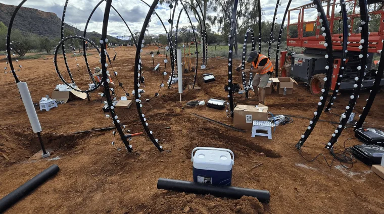 The full array of hoops in daylight before dark, tools and cabling still on the ground and the ranges beyond