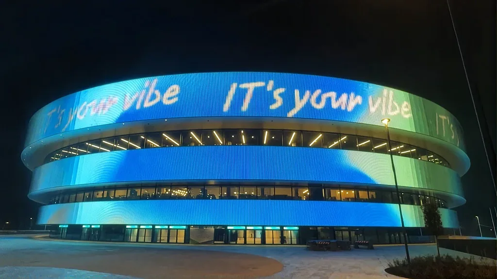 Handwritten graphics running across the lit façade