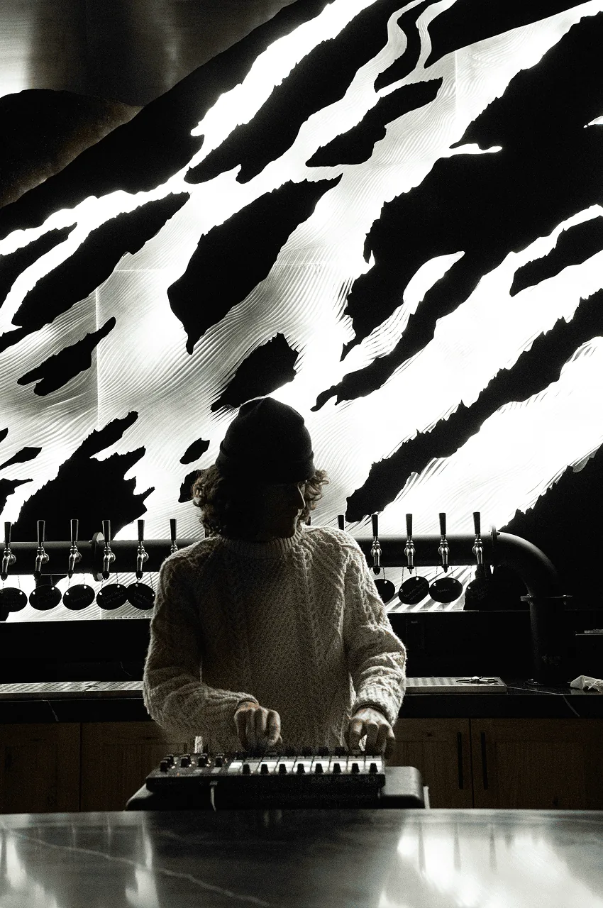 The carved slopes lit bright white, high contrast against the dark ceiling